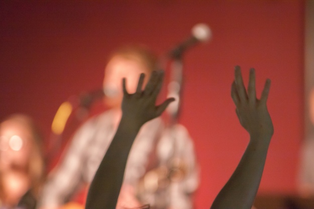 Hands raised in Christian worship service at Sojourn Community Church in Louisville